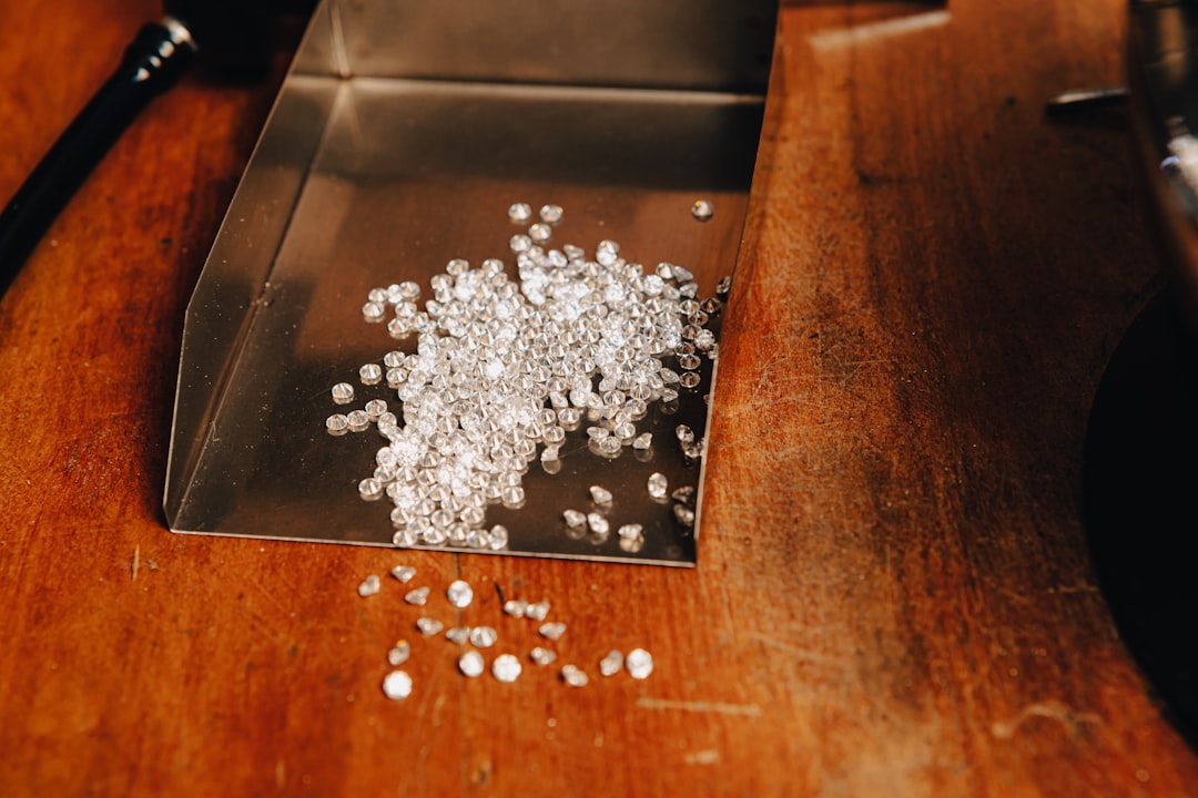 a-pile-of-white-beads-sitting-on-top-of-a-wooden-table-nlcdtfwsgji