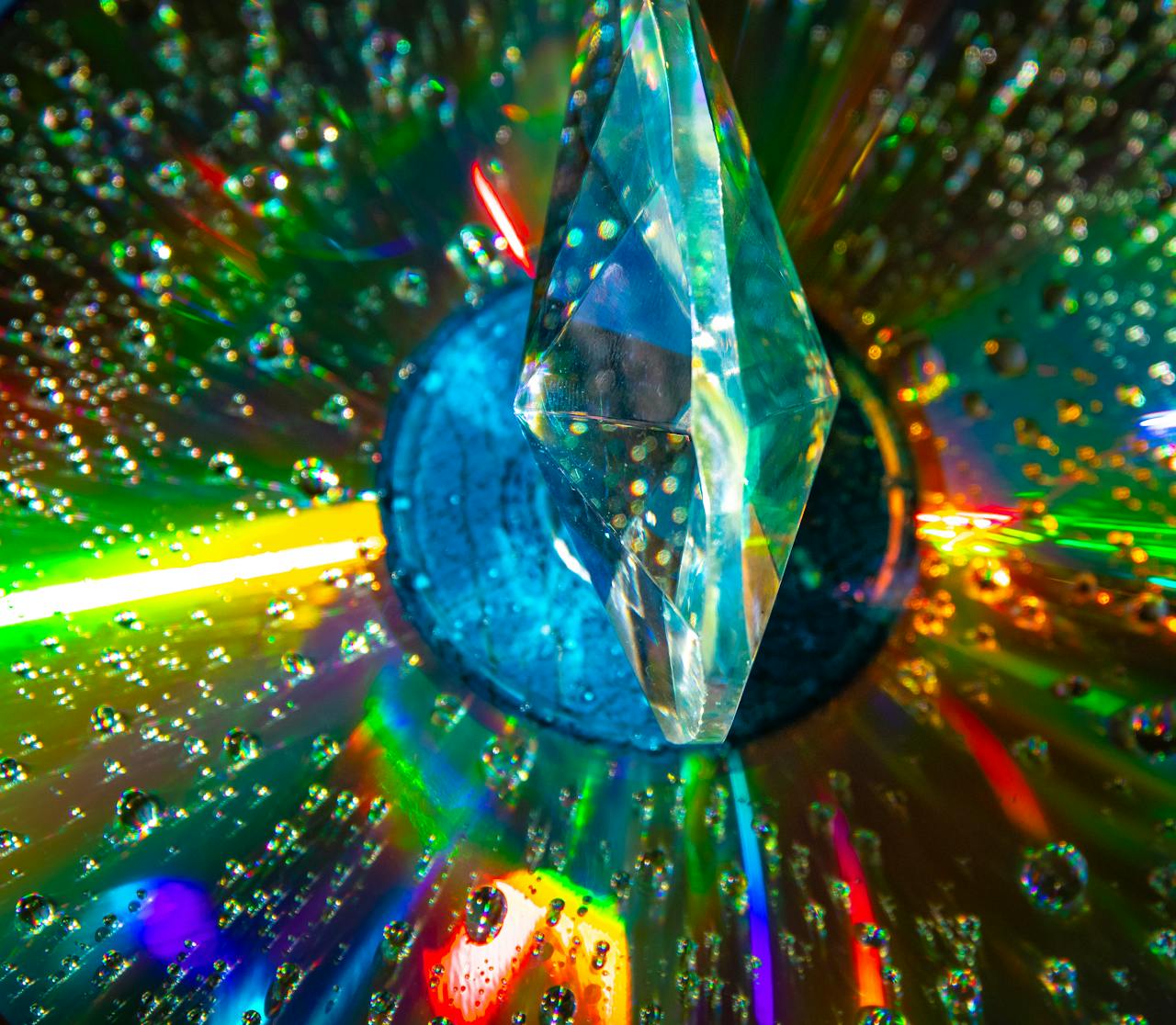 A crystal prism reflects colorful rainbow patterns, captured with vibrant detail and clarity.